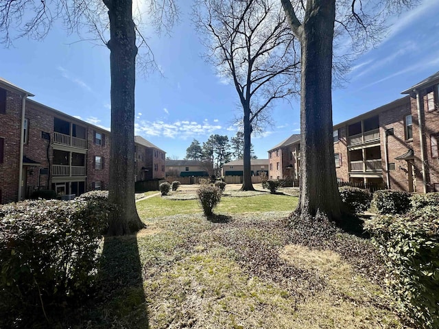 view of property's community with a lawn