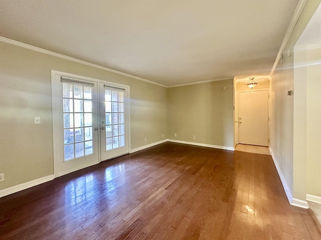 unfurnished room featuring dark wood-style flooring, baseboards, crown molding, and french doors