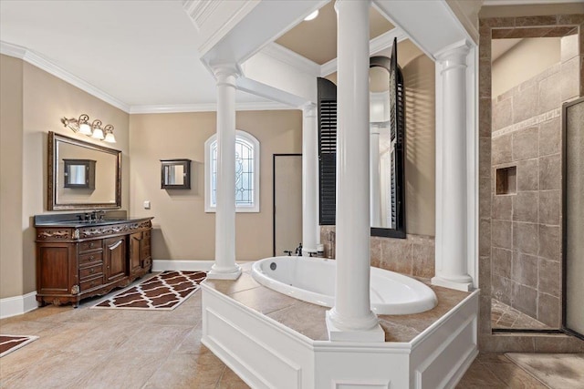 bathroom featuring ornate columns, ornamental molding, and a garden tub