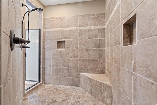 bathroom with a tile shower