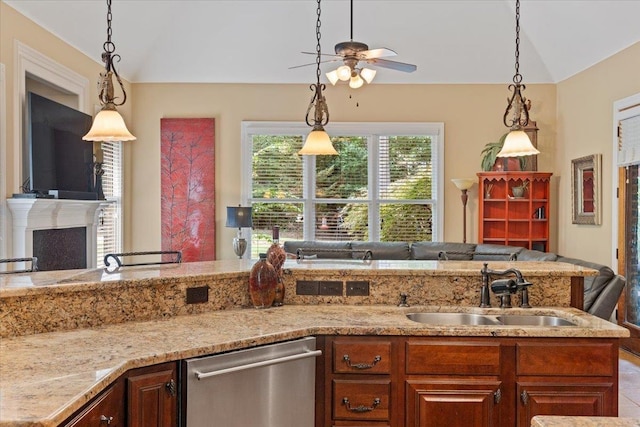 kitchen with decorative light fixtures, a fireplace, open floor plan, a sink, and dishwasher