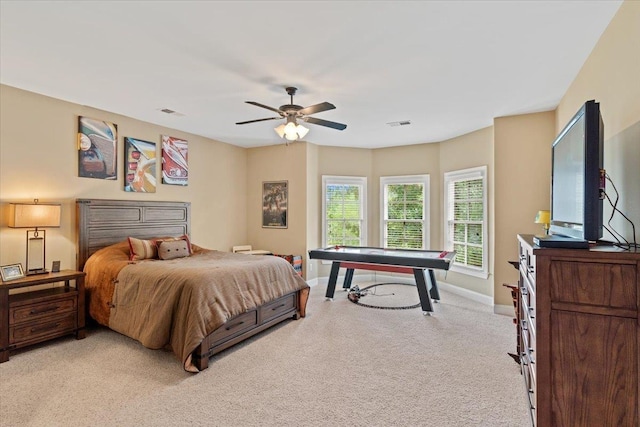 bedroom with light carpet, visible vents, a ceiling fan, and baseboards