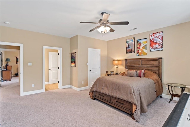 bedroom with baseboards, visible vents, ceiling fan, and light colored carpet