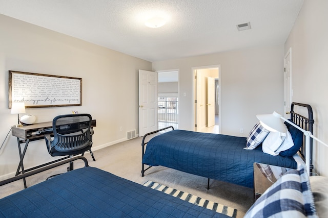 bedroom with baseboards, a textured ceiling, visible vents, and light colored carpet