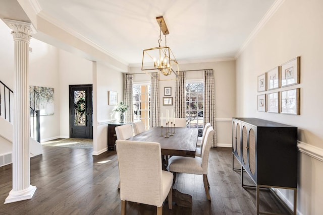 dining space featuring dark wood-style flooring, stairway, and ornate columns