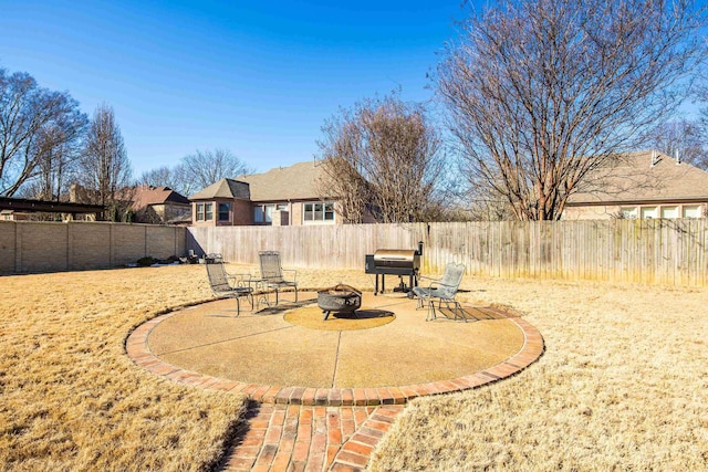 view of yard with a fire pit, a patio area, and a fenced backyard