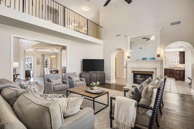 living area featuring light wood finished floors, visible vents, and a ceiling fan