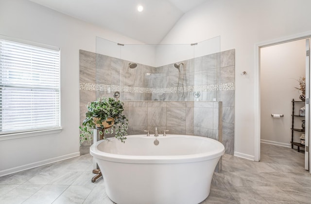 bathroom with lofted ceiling, baseboards, walk in shower, and a freestanding bath