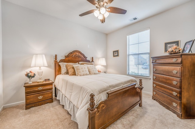 bedroom with a ceiling fan, light carpet, visible vents, and baseboards