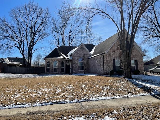 view of front of property featuring brick siding and fence