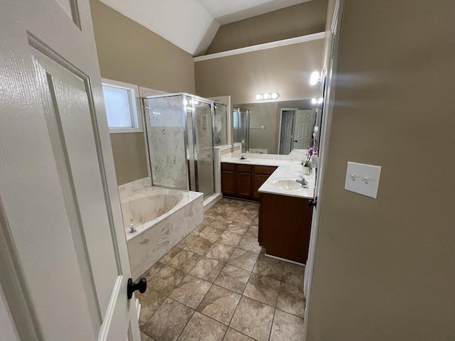 bathroom featuring vaulted ceiling, a tub with jets, a shower stall, and vanity