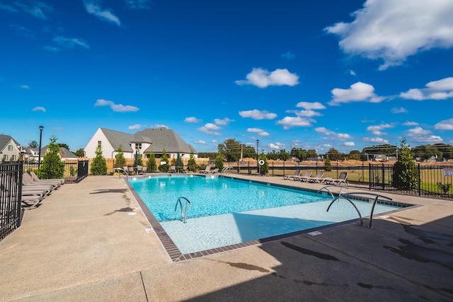 pool featuring a patio area and fence