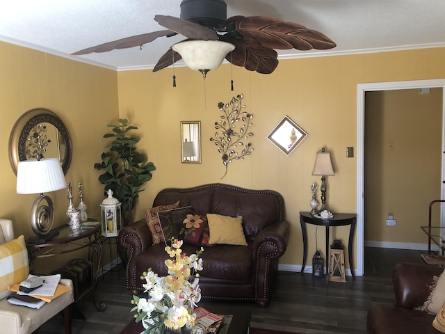 living room featuring dark wood-style floors, baseboards, a ceiling fan, and crown molding