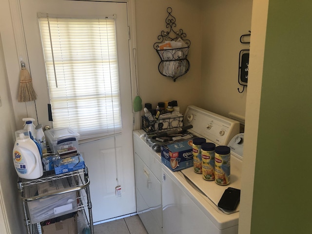 washroom with light tile patterned floors, laundry area, and independent washer and dryer