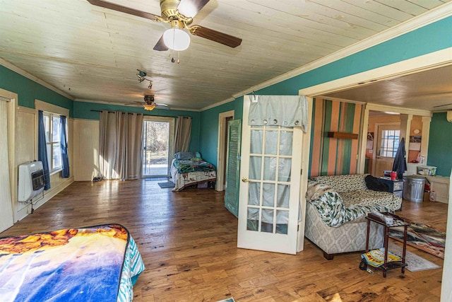 bedroom featuring wood ceiling, ornamental molding, hardwood / wood-style flooring, and heating unit