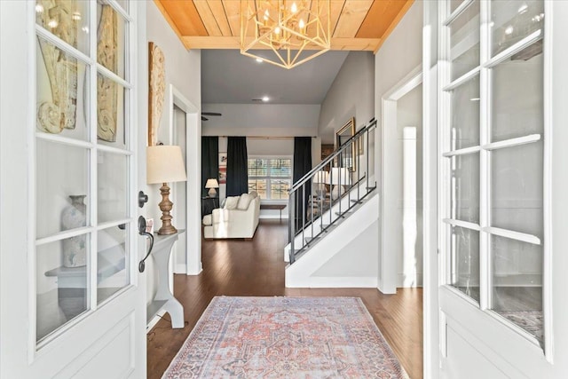 entrance foyer featuring stairway, wood finished floors, and a notable chandelier