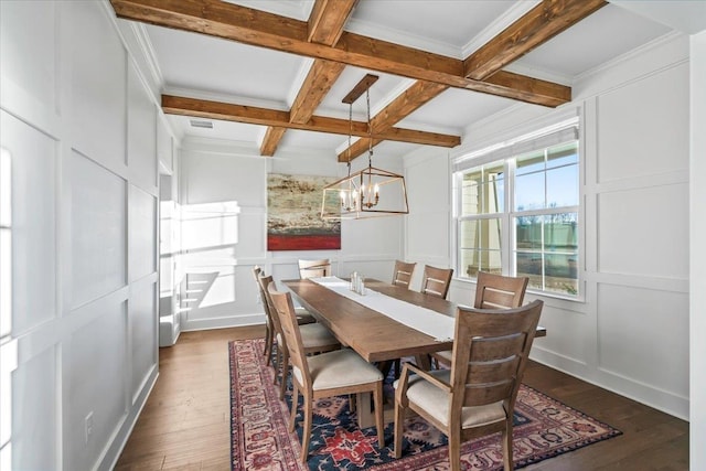 dining area featuring beam ceiling, a decorative wall, an inviting chandelier, dark wood-type flooring, and coffered ceiling