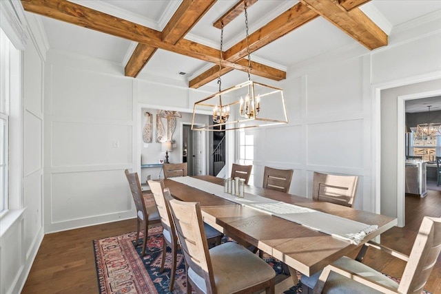 dining area with coffered ceiling, a chandelier, a decorative wall, and beam ceiling