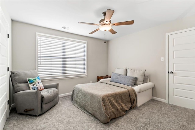 carpeted bedroom with a ceiling fan, visible vents, and baseboards