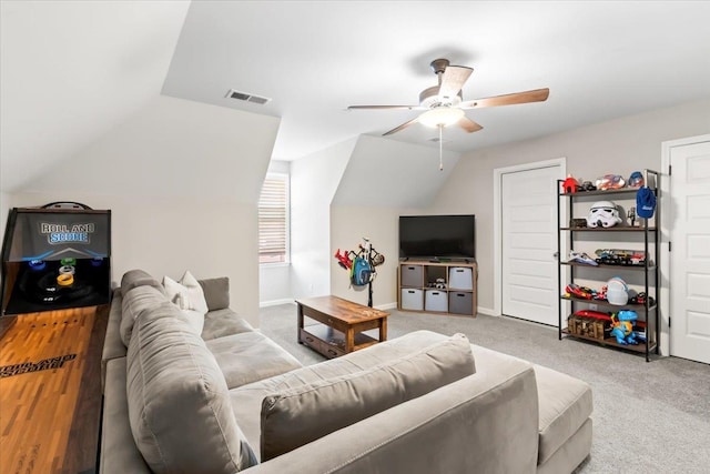 living area featuring lofted ceiling, visible vents, baseboards, a ceiling fan, and carpet