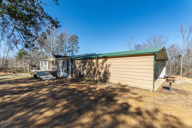 rear view of property with a wooden deck