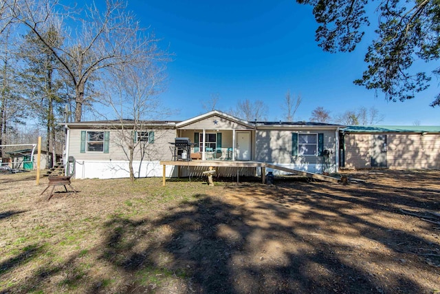 rear view of house featuring a deck