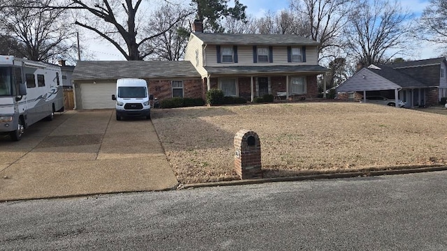 traditional-style home with driveway, brick siding, a chimney, and an attached garage