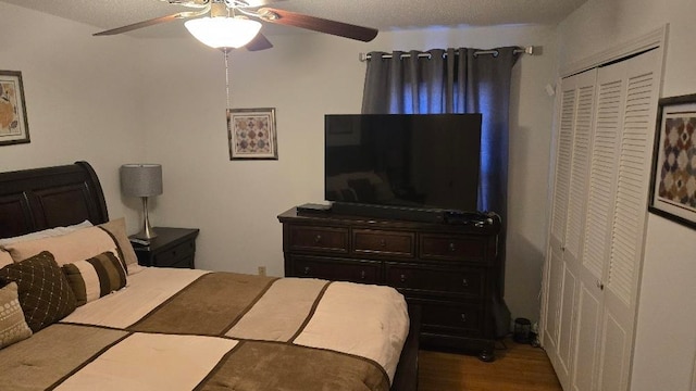 bedroom with ceiling fan, a closet, and wood finished floors