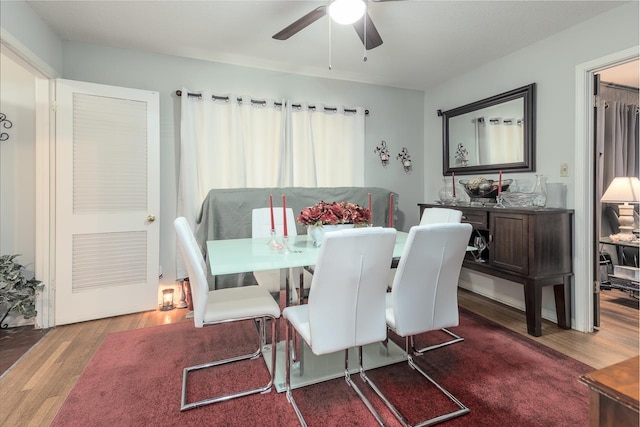 dining room featuring ceiling fan and wood finished floors