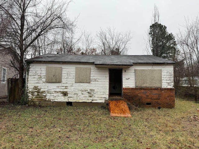 view of front facade with crawl space, a front yard, and brick siding