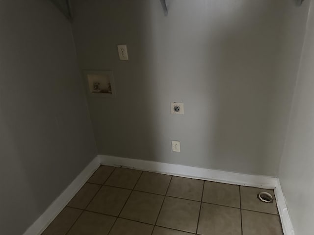 clothes washing area featuring laundry area, baseboards, tile patterned floors, hookup for a washing machine, and electric dryer hookup