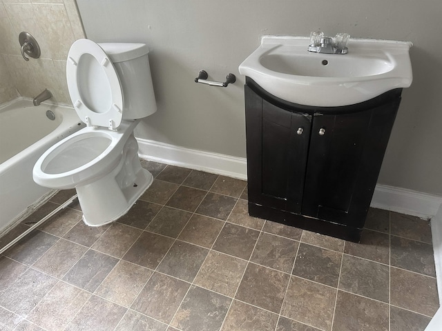 bathroom with vanity, toilet, and baseboards