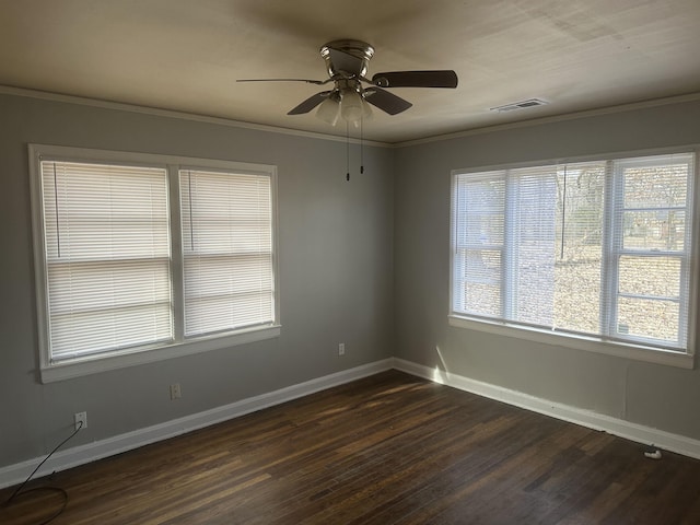 unfurnished room featuring baseboards, visible vents, dark wood-type flooring, and ornamental molding