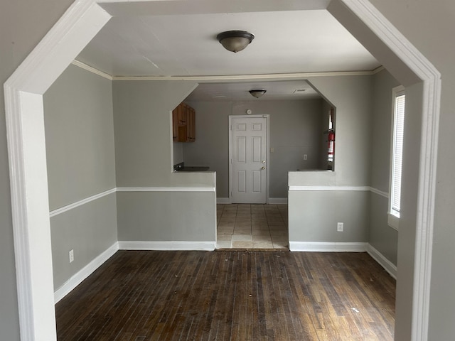 spare room with hardwood / wood-style flooring, baseboards, and ornamental molding