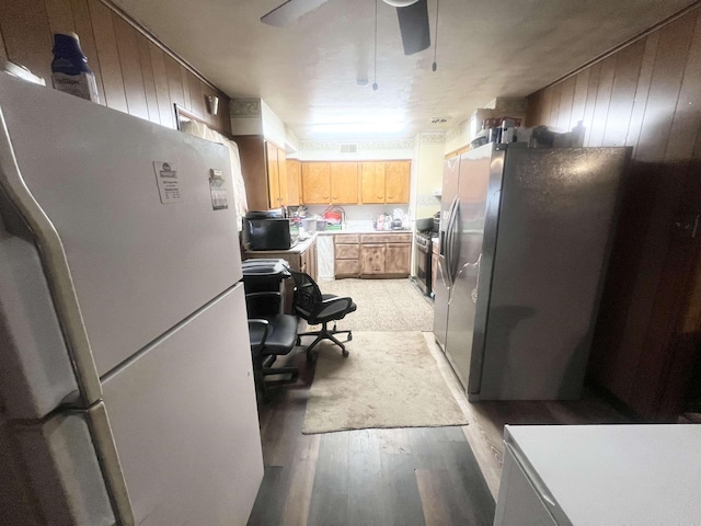 kitchen featuring ceiling fan, light wood-style floors, light countertops, freestanding refrigerator, and stainless steel fridge