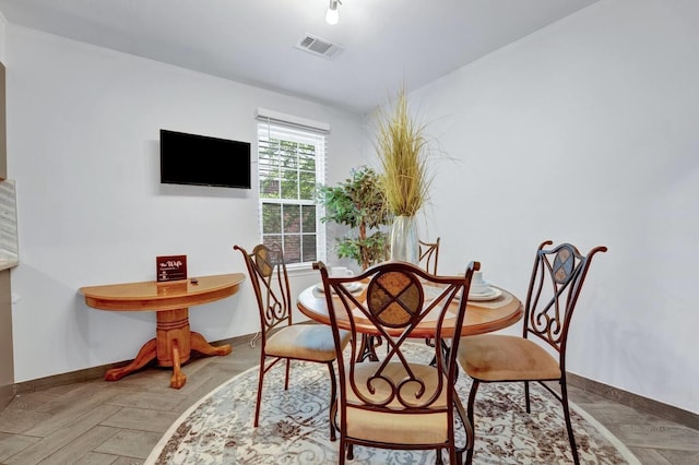 dining room featuring visible vents and baseboards