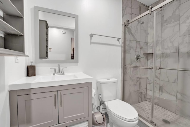 full bathroom featuring a stall shower, vanity, and toilet