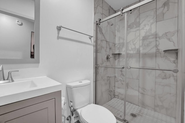 full bathroom with a stall shower, vanity, and toilet