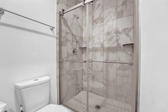 full bathroom with toilet and a shower stall