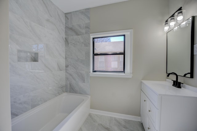 full bath featuring marble finish floor, vanity, and baseboards