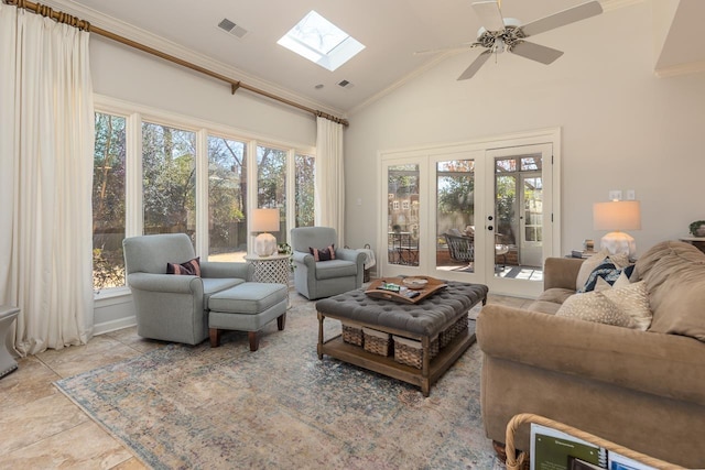 living room with a healthy amount of sunlight, a skylight, visible vents, and crown molding