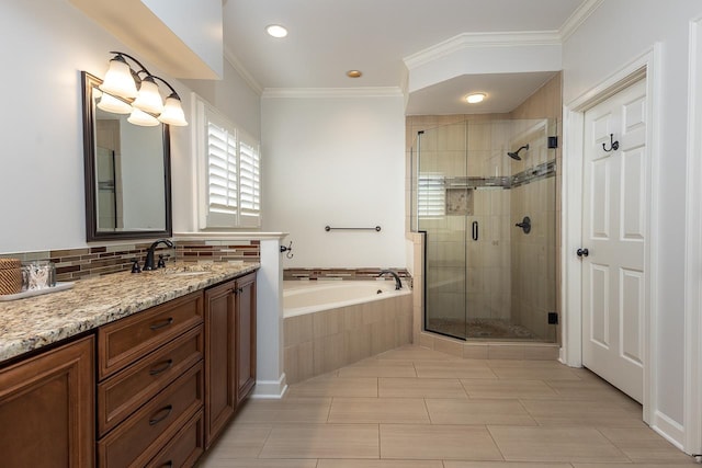 full bath featuring a shower stall, ornamental molding, a bath, and vanity