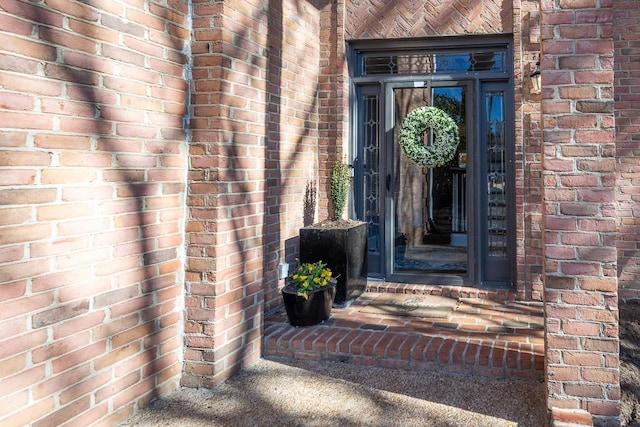 entrance to property with brick siding