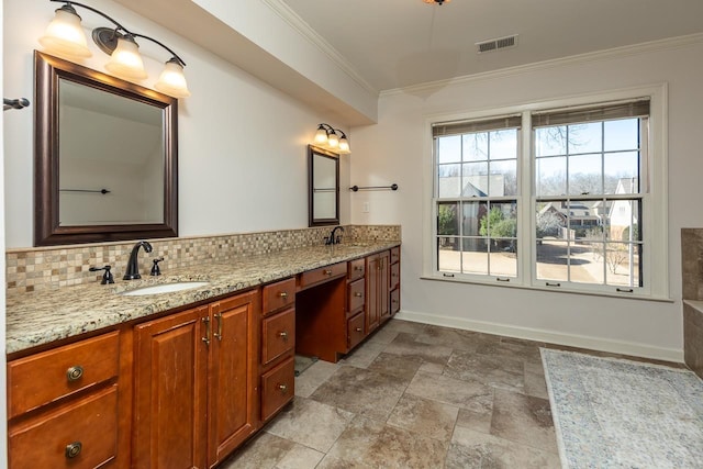 full bath with a sink, visible vents, decorative backsplash, double vanity, and crown molding