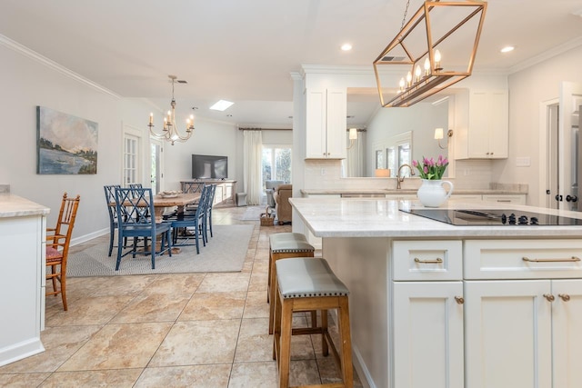 kitchen with backsplash, white cabinetry, black electric cooktop, and crown molding