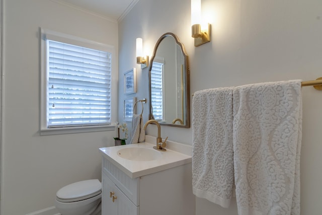 bathroom featuring vanity, toilet, and crown molding