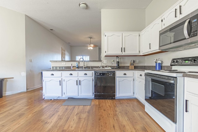 kitchen with a peninsula, electric stove, dishwasher, stainless steel microwave, and dark countertops