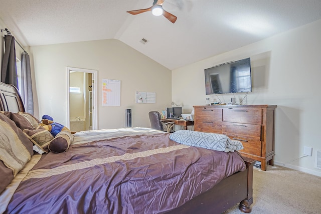 carpeted bedroom with ensuite bathroom, a ceiling fan, visible vents, vaulted ceiling, and baseboards