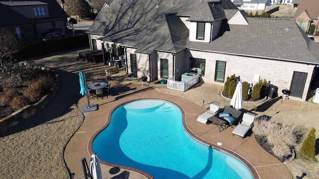 outdoor pool featuring a patio and central air condition unit