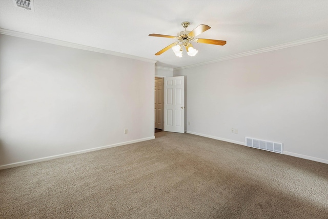 unfurnished room with ornamental molding, carpet, visible vents, and baseboards